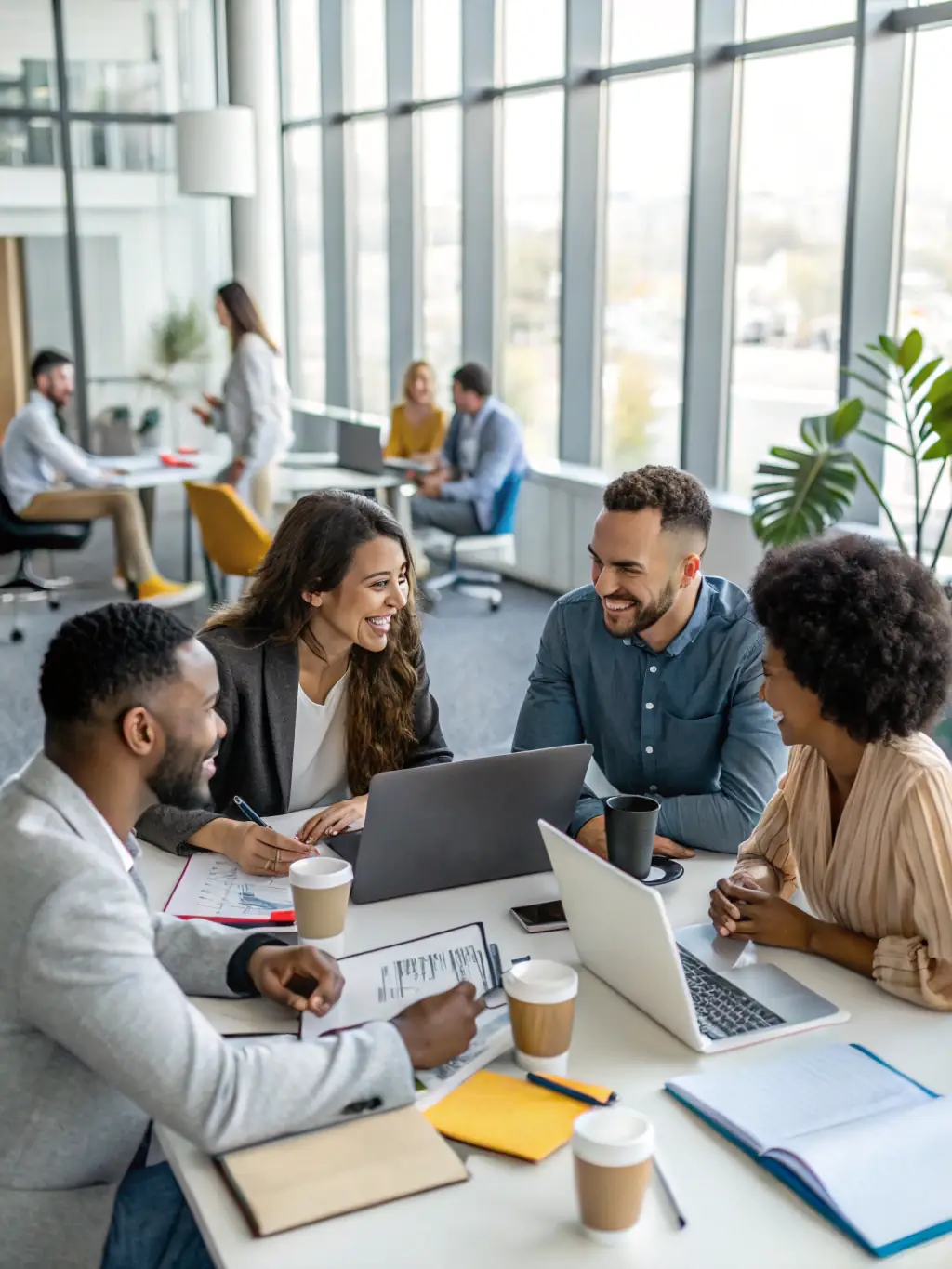 A diverse group of professionals engaged in a lively multiparty negotiation around a large conference table, with documents and laptops scattered around, showcasing active listening and collaborative problem-solving.